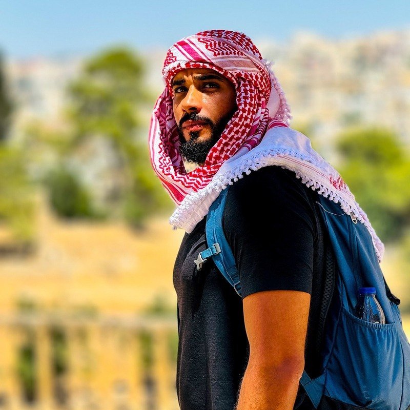 Mohamed Taher wearing a red keffiyeh